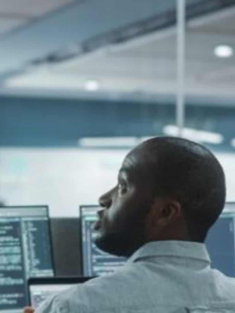 Cybersecurity consultants around a computer