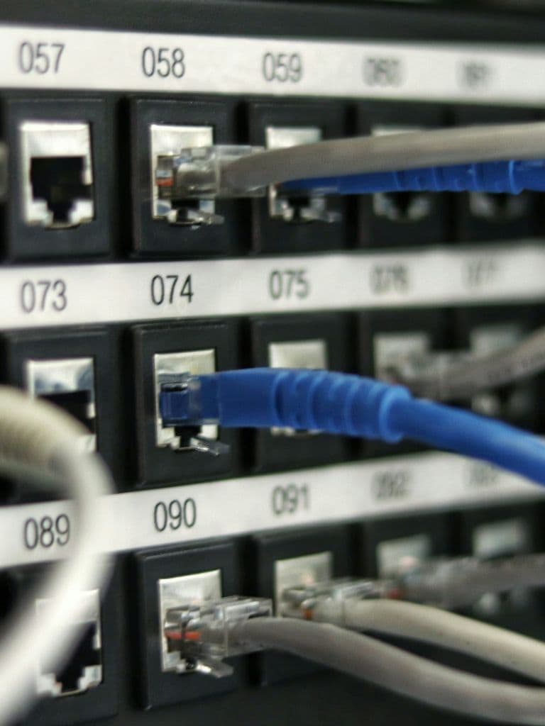 Network patch panel with Ethernet cabling representing secure network access