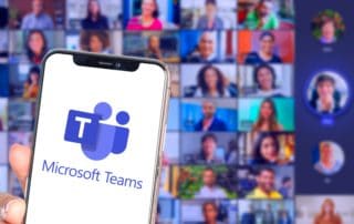 phone with microsoft teams app in front of a large audience in a video call