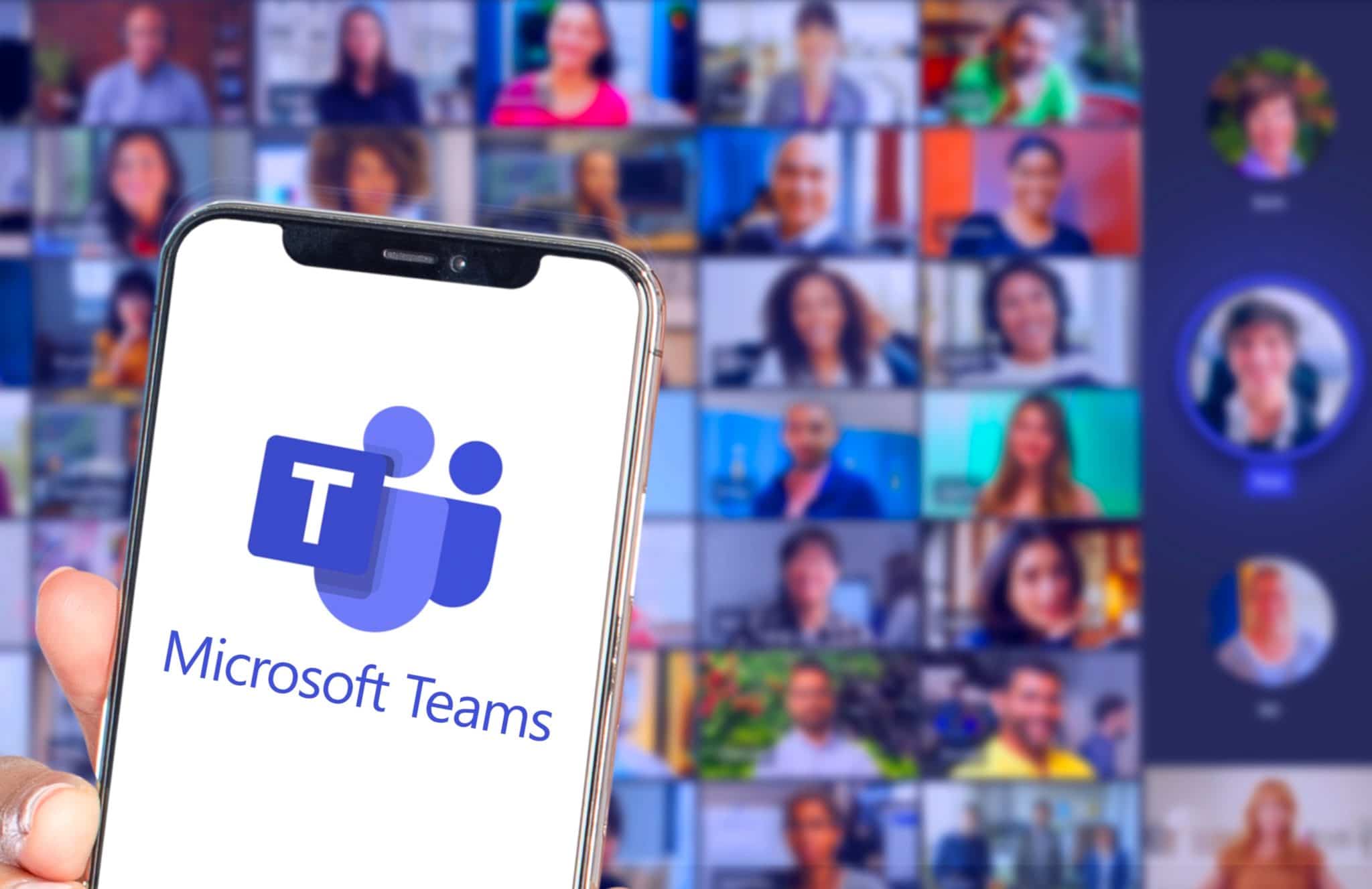 phone with microsoft teams app in front of a large audience in a video call